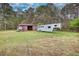 The backyard has a shed, trailer, and luscious green grass at 1277 Bethany Rd, Covington, GA 30016