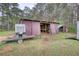 Rustic barn featuring metal siding, open stalls, and adjacent trailer at 1277 Bethany Rd, Covington, GA 30016