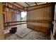 View of a barn stall featuring metal siding and a bucket at 1277 Bethany Rd, Covington, GA 30016