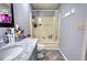This bathroom features a marble countertop, a sink, a toilet, and a bathtub with a shower at 1277 Bethany Rd, Covington, GA 30016
