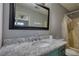 The bathroom features a large mirror, a marble countertop, and a tub/shower combo at 1277 Bethany Rd, Covington, GA 30016