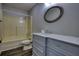Clean bathroom features a marble vanity, framed mirror, and a combined shower/tub at 1277 Bethany Rd, Covington, GA 30016