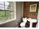 The bathroom features brick walls, a pedestal sink, a standard toilet, and a window with natural light at 1277 Bethany Rd, Covington, GA 30016