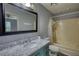 The bathroom features a large mirror, a marble countertop, and a tub/shower combo at 1277 Bethany Rd, Covington, GA 30016