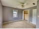 A carpeted bedroom features a small window, an open closet, and gray painted walls at 1277 Bethany Rd, Covington, GA 30016