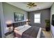 Well-lit bedroom features neutral walls, ceiling fan, TV, and a comfortable bed at 1277 Bethany Rd, Covington, GA 30016