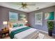 Bright bedroom has neutral walls, ceiling fan, and two windows at 1277 Bethany Rd, Covington, GA 30016