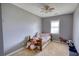 View of small bedroom with single bed, ceiling fan, carpet, window, and toys on the floor at 1277 Bethany Rd, Covington, GA 30016