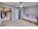 Bright bedroom featuring carpet floors, ceiling fan, closet, and a twin size bed at 1277 Bethany Rd, Covington, GA 30016