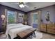 A bright bedroom features two windows, an iron bed, wooden furniture, and carpet at 1277 Bethany Rd, Covington, GA 30016