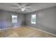 Empty bedroom with neutral walls, carpeted floors, and natural light from two windows at 1277 Bethany Rd, Covington, GA 30016