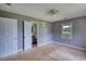 A carpeted bedroom with access to a bathroom and a closet with a window at 1277 Bethany Rd, Covington, GA 30016