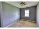 Cozy bedroom with carpet, neutral walls, a window, and a ceiling fan at 1277 Bethany Rd, Covington, GA 30016