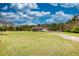 A ranch-style home with a sprawling green lawn and trees in the background at 1277 Bethany Rd, Covington, GA 30016