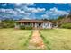 Charming home exterior with a covered porch, surrounded by a green lawn at 1277 Bethany Rd, Covington, GA 30016