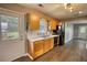 Charming kitchen boasts wooden cabinets, a black dishwasher, and an exit door, offering both style and function at 1277 Bethany Rd, Covington, GA 30016
