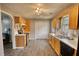 Bright kitchen with wooden cabinets, laminate floors, and modern appliances, open to other spaces at 1277 Bethany Rd, Covington, GA 30016