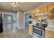 Well-lit kitchen with stainless steel oven, wooden cabinets, and modern appliances, flowing into the living area at 1277 Bethany Rd, Covington, GA 30016