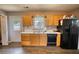Bright kitchen with wood cabinets, stainless sink, and black dishwasher at 1277 Bethany Rd, Covington, GA 30016