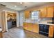 Functional kitchen featuring wood cabinets, black appliances, and in-kitchen laundry at 1277 Bethany Rd, Covington, GA 30016