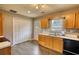Functional kitchen showcases wooden cabinets, a sink, and laminate floors, leading to backyard access at 1277 Bethany Rd, Covington, GA 30016