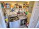 Laundry area featuring an LG washer and dryer set with shelves filled with household items at 1277 Bethany Rd, Covington, GA 30016