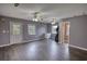 Expansive living room with neutral walls, gray laminate flooring, and access to the outdoors and adjacent rooms at 1277 Bethany Rd, Covington, GA 30016
