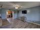 Open-concept living room boasts wood-look flooring and easy access to the kitchen at 1277 Bethany Rd, Covington, GA 30016