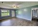 Living room with wood-look floors, ceiling fan and natural light from the window at 1277 Bethany Rd, Covington, GA 30016