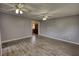 Spacious living room featuring laminate floors and three ceiling fans, offering a bright and airy atmosphere at 1277 Bethany Rd, Covington, GA 30016