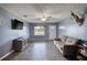 Spacious living room with a decorative ceiling fan, modern flooring, and comfortable seating at 1277 Bethany Rd, Covington, GA 30016