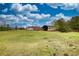 The beautiful property displays a residence, expansive lawn, barn, shed, and lots of space at 1277 Bethany Rd, Covington, GA 30016