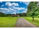 Long driveway leading to a single story house surrounded by a green yard at 1277 Bethany Rd, Covington, GA 30016