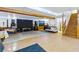 Spacious basement with hardwood floors, exposed beams, stage setup, and adjacent staircase at 208 Wellington Walk, Douglasville, GA 30134