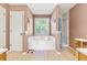 Relaxing bathroom featuring a large tub, separate shower, and neutral decor at 208 Wellington Walk, Douglasville, GA 30134