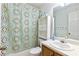 Bathroom featuring a vanity, toilet, shower with patterned curtain, and storage shelves at 208 Wellington Walk, Douglasville, GA 30134