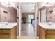 Ensuite bathroom with double sinks and an open doorway to the bedroom at 208 Wellington Walk, Douglasville, GA 30134