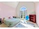 Bright bedroom with a large window, pink walls, and simple furnishings for a cozy feel at 208 Wellington Walk, Douglasville, GA 30134