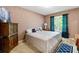 Cozy bedroom with neutral tones, a comfortable bed, and a bright window view at 208 Wellington Walk, Douglasville, GA 30134