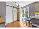 Cozy dining area with hardwood floors, bright window, and a barn door to pantry at 208 Wellington Walk, Douglasville, GA 30134