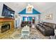 Spacious living room with a stone fireplace, comfortable leather sofas, and a view into the dining area at 208 Wellington Walk, Douglasville, GA 30134