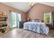 Spacious main bedroom with vaulted ceiling, two windows, and wood-look flooring at 208 Wellington Walk, Douglasville, GA 30134