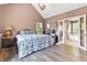 Bright main bedroom with vaulted ceiling, chandelier, and ensuite bathroom access at 208 Wellington Walk, Douglasville, GA 30134