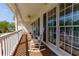 Inviting front porch with white rocking chairs, ceiling fan, and ample natural light from the large windows at 208 Wellington Walk, Douglasville, GA 30134