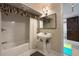 Bathroom with a shower-tub combination, pedestal sink, and neutral-toned decor at 3025 Greenfield Dr, Marietta, GA 30068
