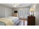Bedroom with shuttered windows, hardwood floors, a dresser, and neutral decor at 3025 Greenfield Dr, Marietta, GA 30068