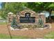 Stone entrance sign for Indian Hills Country Club, with colorful flowers and landscaping at 3025 Greenfield Dr, Marietta, GA 30068