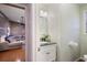 A half bathroom with modern fixtures, stylish vanity, and a glimpse of the wood-paneled living area at 3025 Greenfield Dr, Marietta, GA 30068