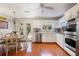 Spacious kitchen featuring stainless steel appliances, white cabinets, an adjacent dining area, and wood flooring for a classic appeal at 3025 Greenfield Dr, Marietta, GA 30068