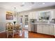 Charming kitchen with stainless appliances, adjacent dining area, and a door leading to the outdoor deck, great for entertaining at 3025 Greenfield Dr, Marietta, GA 30068